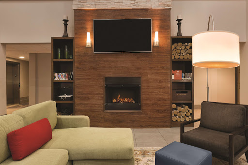 A stylish living room featuring a modern fireplace, built-in shelves, and comfortable seating.
