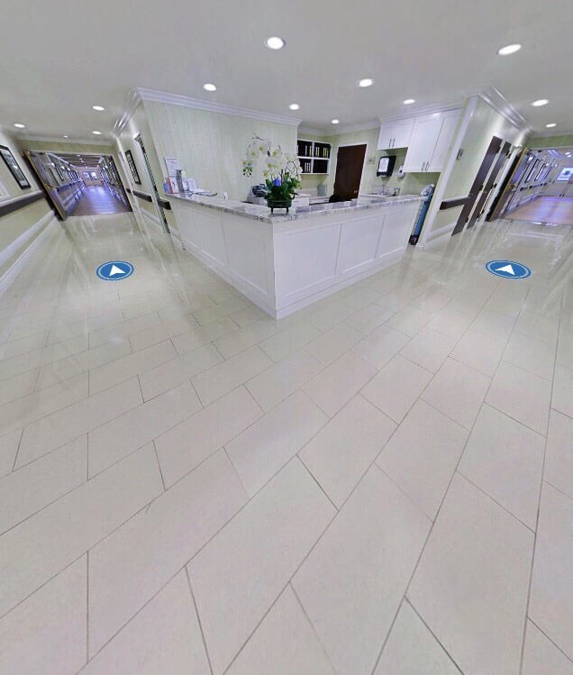 A modern and spacious reception area with white tile flooring and contemporary decor.