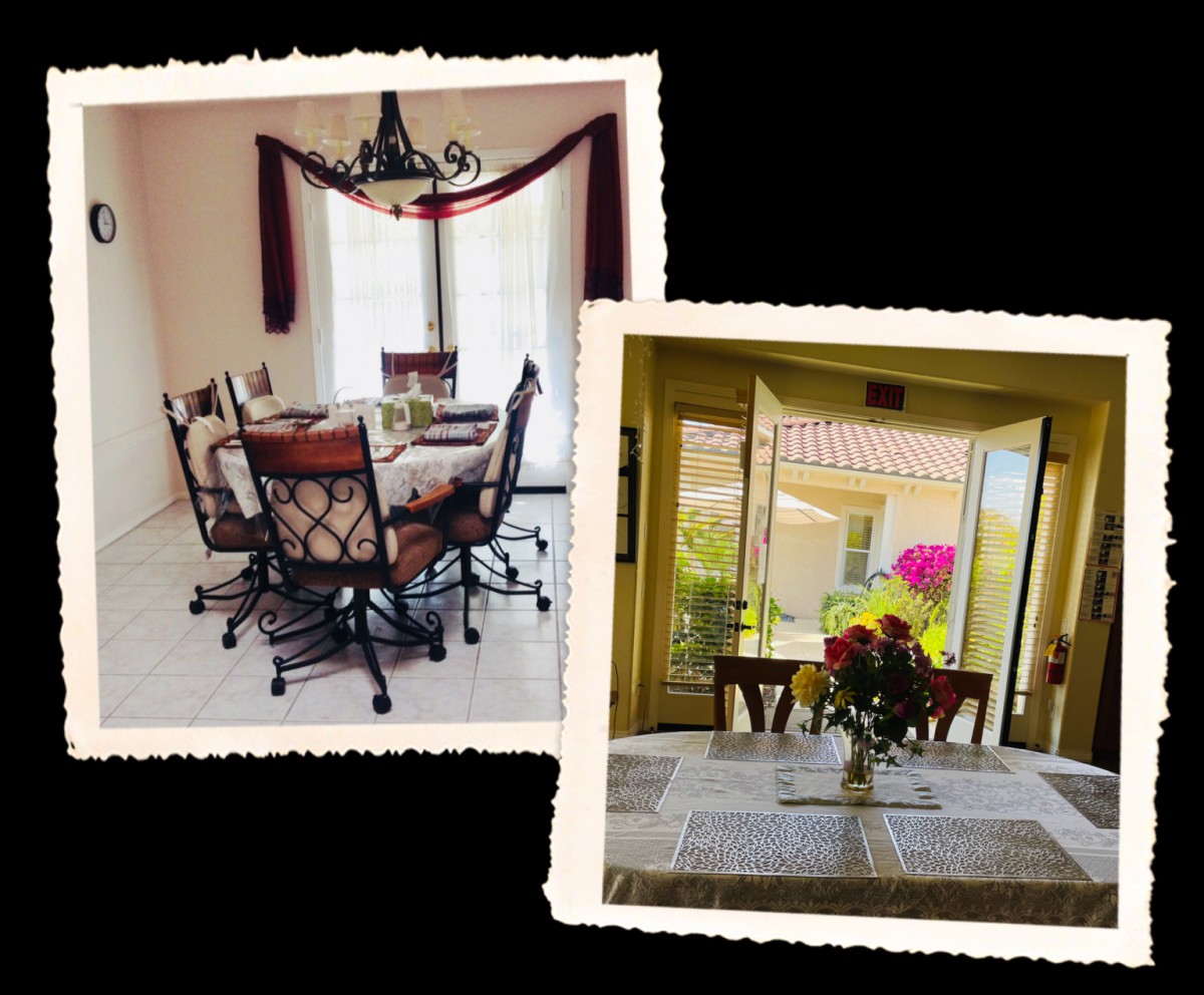 A cozy dining area with a table set, chairs, and floral decor in front of a bright window.