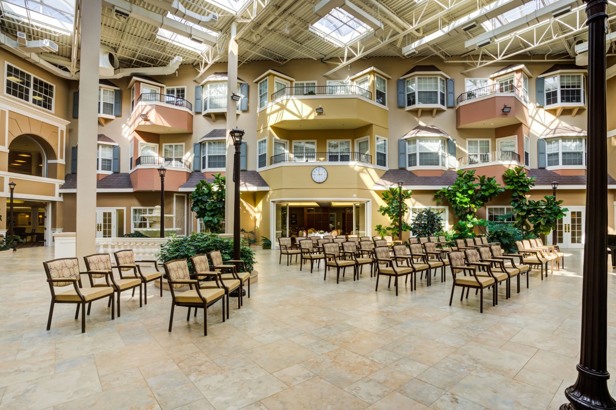A spacious indoor atrium with multiple seating arrangements under abundant natural light.