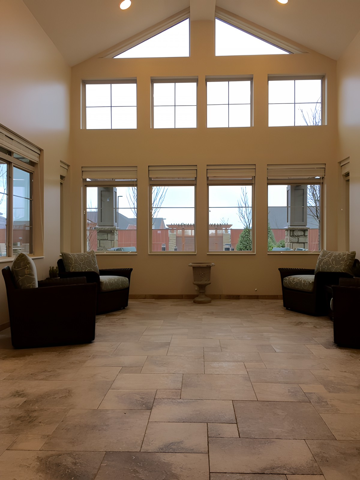 A spacious room with large windows and comfortable seating arrangements.