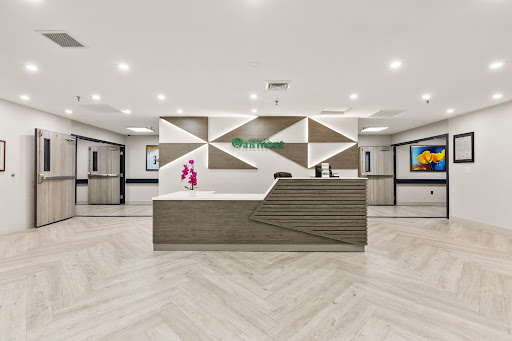 A modern hotel lobby featuring a stylish reception area with geometric design elements.