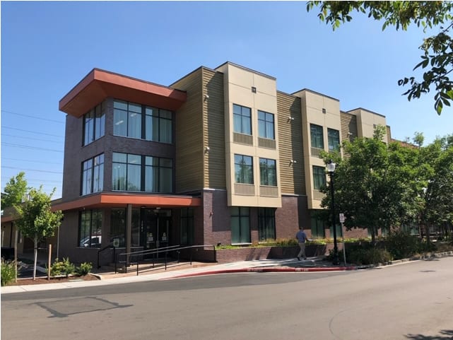A modern commercial building with large windows and a contemporary design.