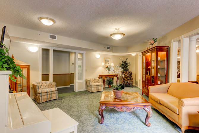A well-furnished living room featuring classic decor, comfortable seating, and a wooden coffee table.