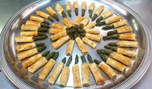A beautifully arranged platter of baked asparagus pastries, perfect for any gathering.