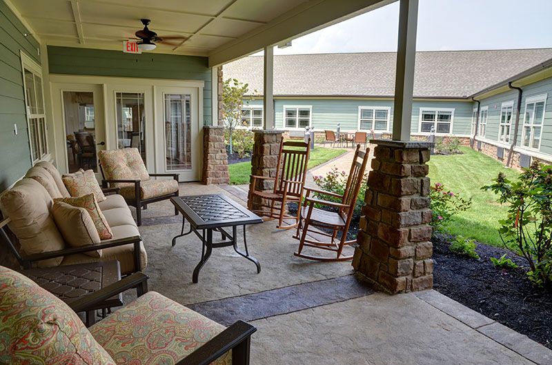 A cozy outdoor patio with comfortable seating and a garden view.