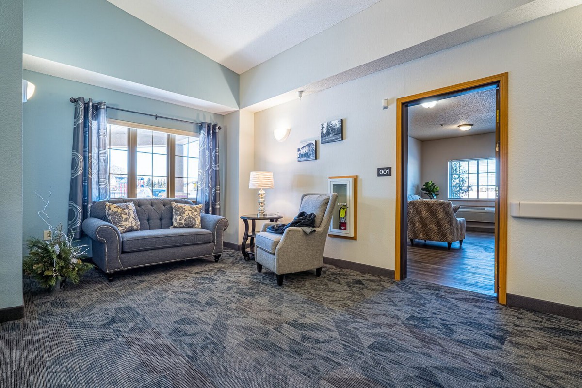 A cozy living room with comfortable seating and large windows.