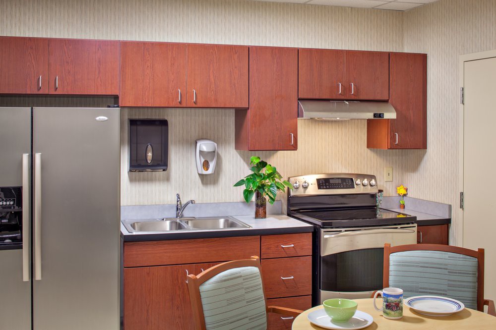 A modern kitchen with wooden cabinets and stainless steel appliances.