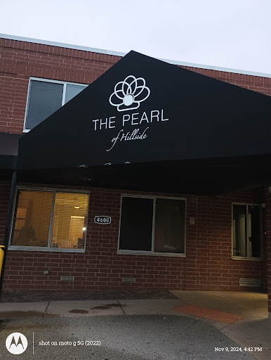 The entrance of The Pearl, featuring a prominent awning with its name.
