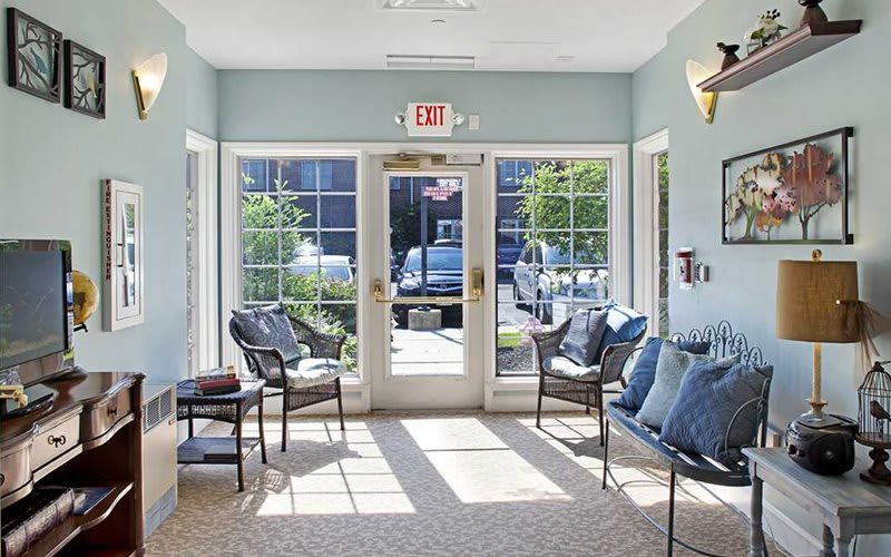 A bright waiting area with comfortable seating and large windows letting in natural light.