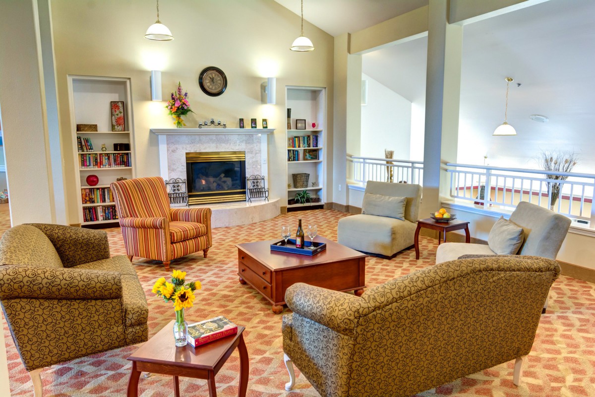 A cozy living room with a fireplace and comfortable seating.