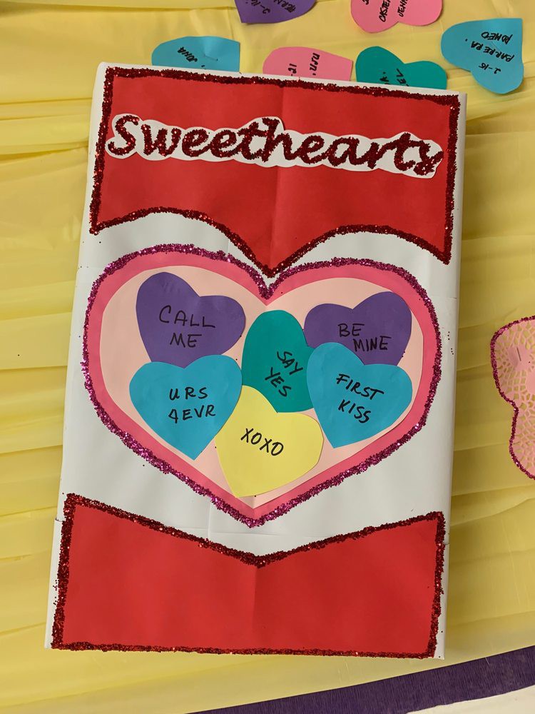 Colorful Valentine's Day sweethearts artwork featuring heart-shaped candies with messages.