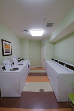 A tidy and organized laundry room with washing machines along both sides.