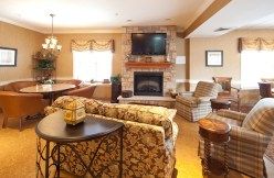 A cozy living room with a brick fireplace and comfortable seating.
