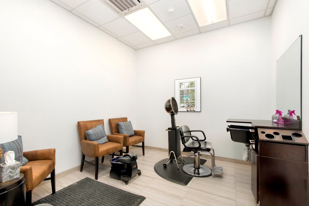 A modern hair salon with a waiting area and styling stations.