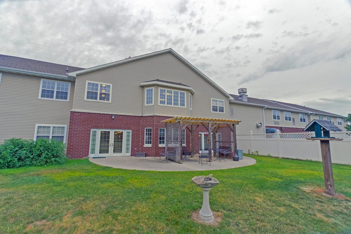 A suburban house with a backyard patio and garden area.