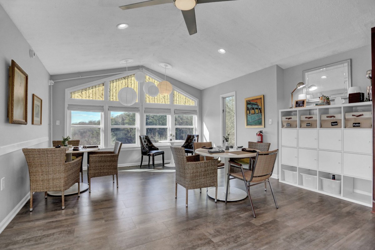 A modern living room with ample natural light and stylish furnishings.
