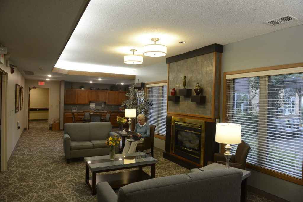 A cozy living room with comfortable seating, a fireplace, and warm lighting.