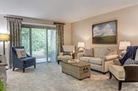 A cozy living room with comfortable seating and large windows.