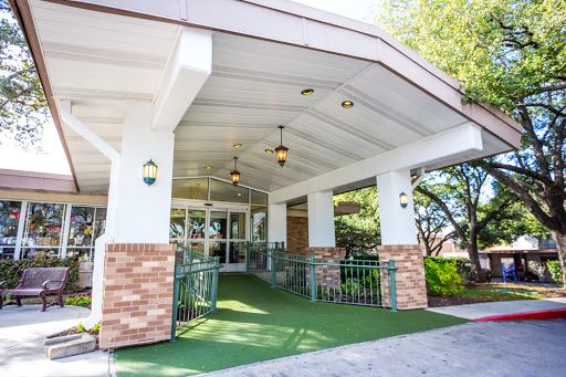 The welcoming entrance of a modern building, featuring an accessible pathway and stylish lighting.