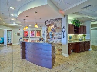 A modern reception area with stylish lighting and artwork on the walls.