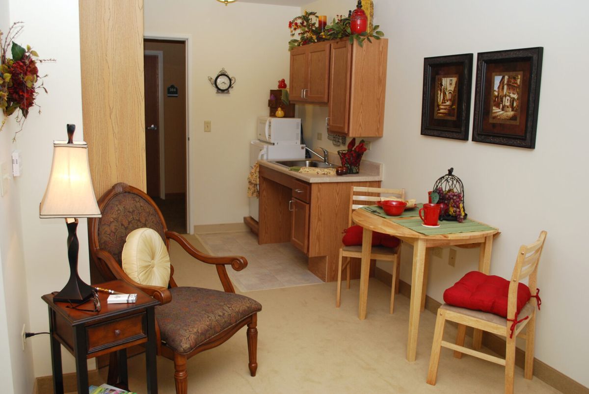 Cozy kitchen and dining area with wooden cabinets and a small table setup.