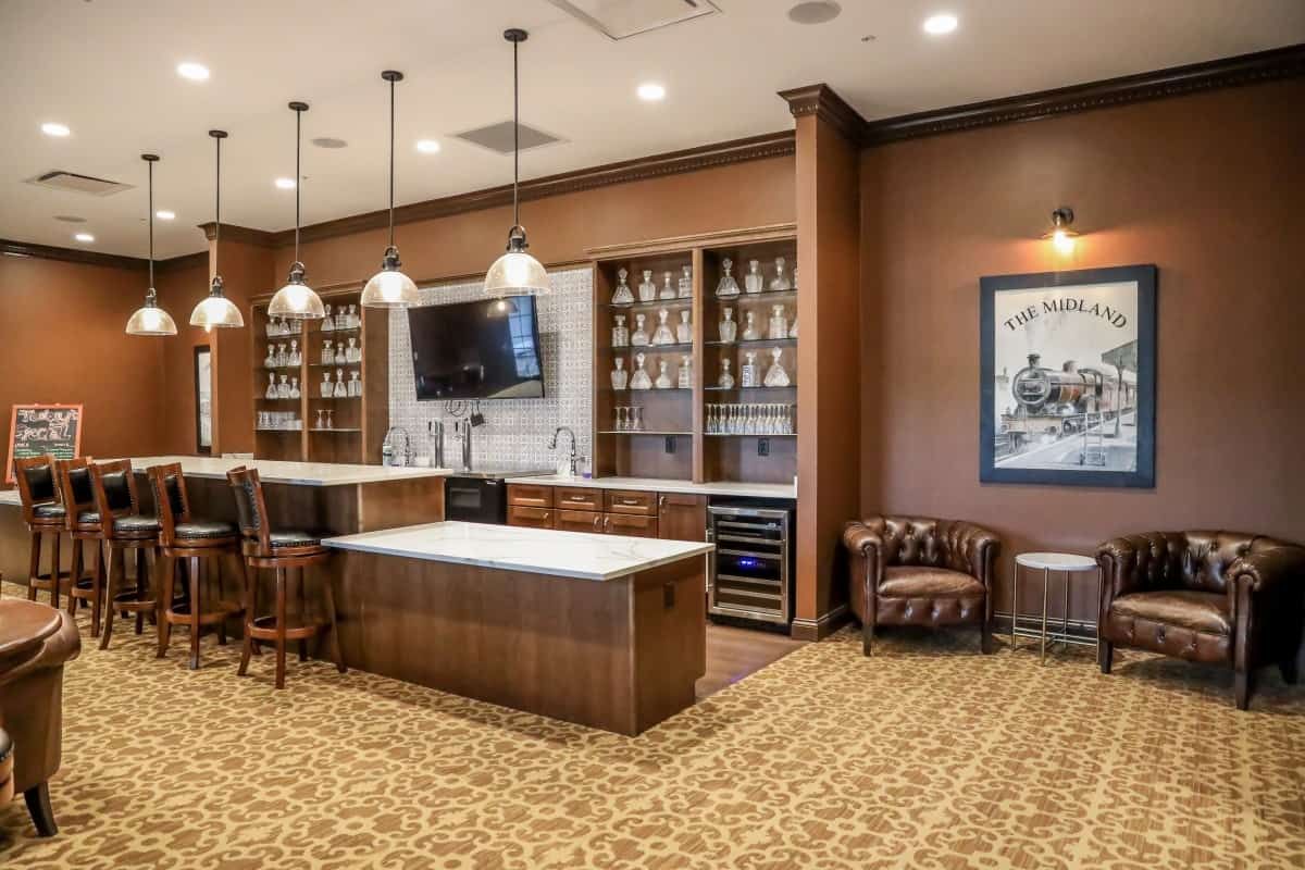 A luxurious kitchen and bar area with modern decor and seating options.