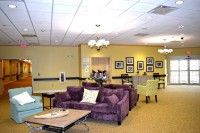 A comfortable lounge area with sofas and tables, decorated in warm tones.