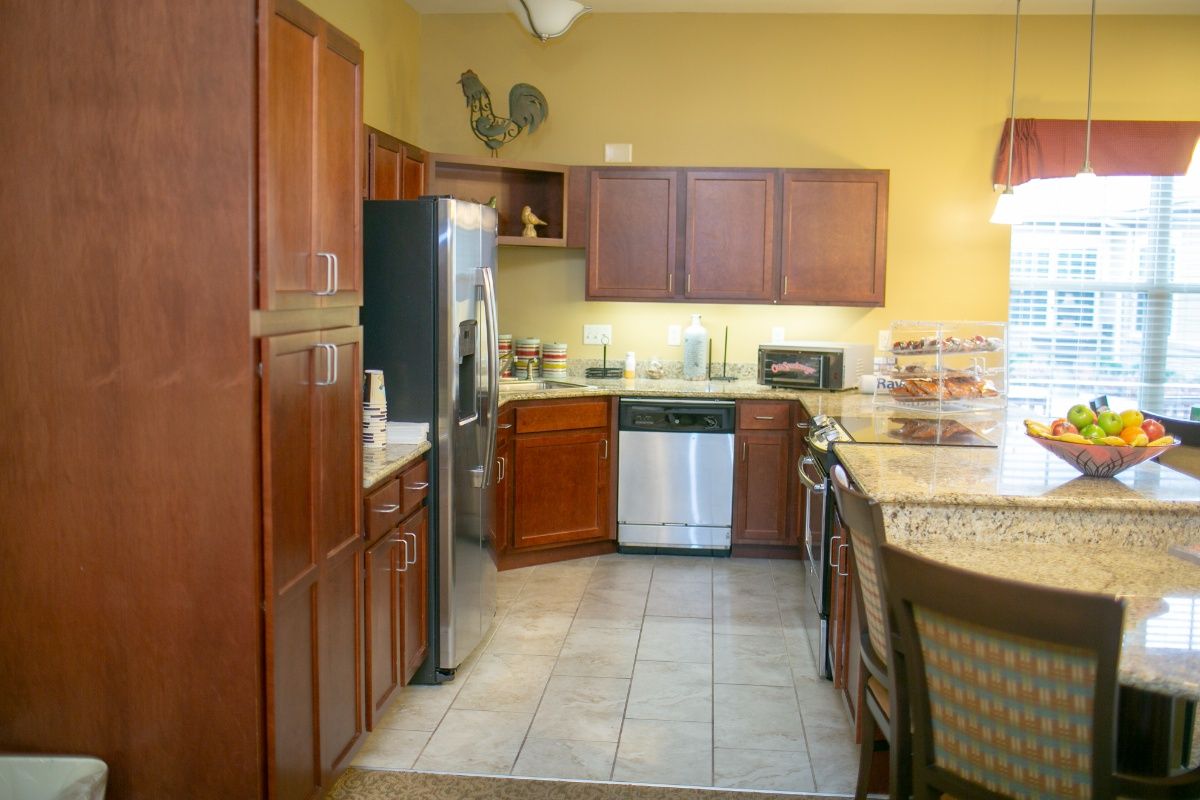 A modern kitchen with wooden cabinets and stainless steel appliances.