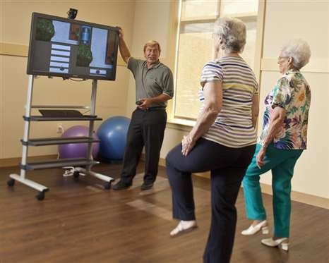 Seniors participating in a fitness class focused on balance exercises.