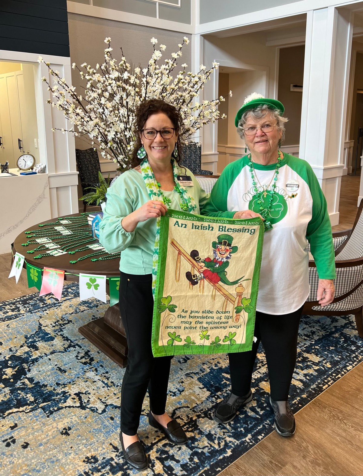 Two people celebrating St. Patrick's Day with festive attire and decorations.