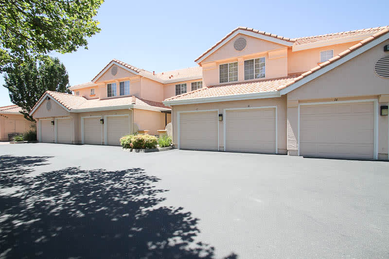 A row of suburban townhouses with attached garages.