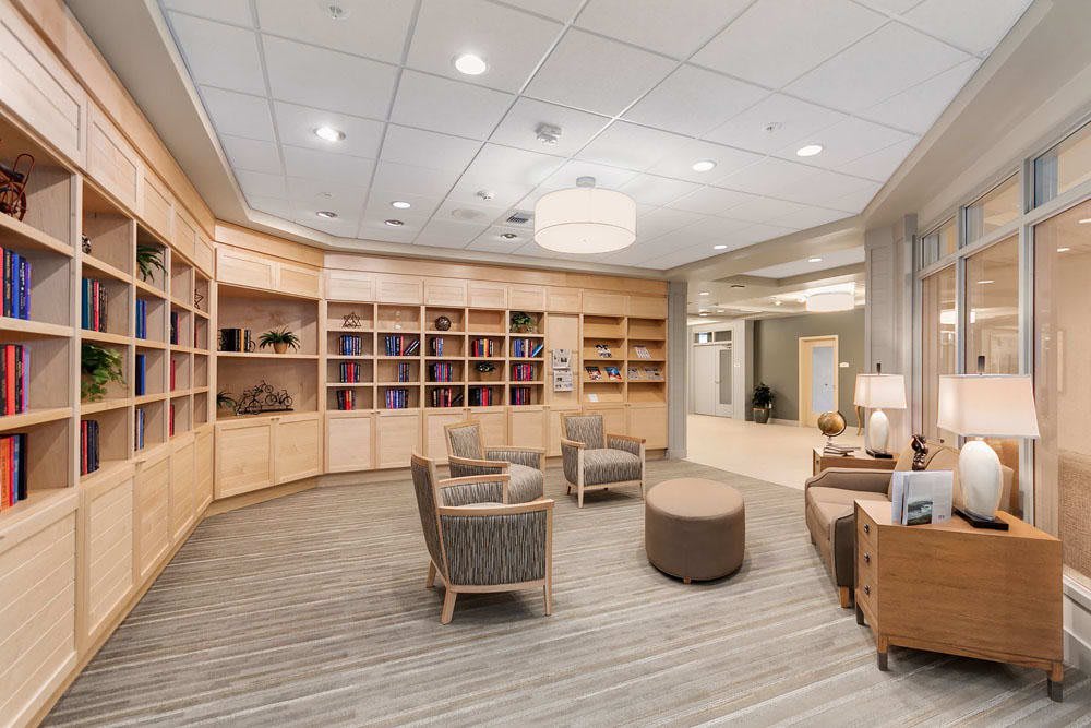 A modern library interior with comfortable seating and bookshelves.
