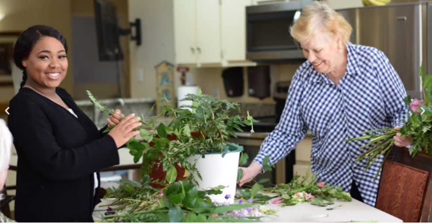 Two people enjoying a gardening activity together in the kitchen.