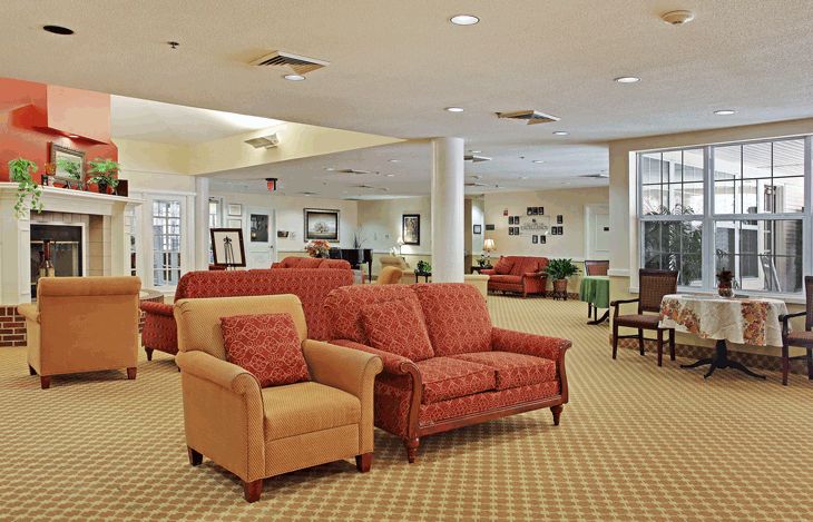 A spacious living room with comfortable sofas and chairs arranged in a cozy seating area.