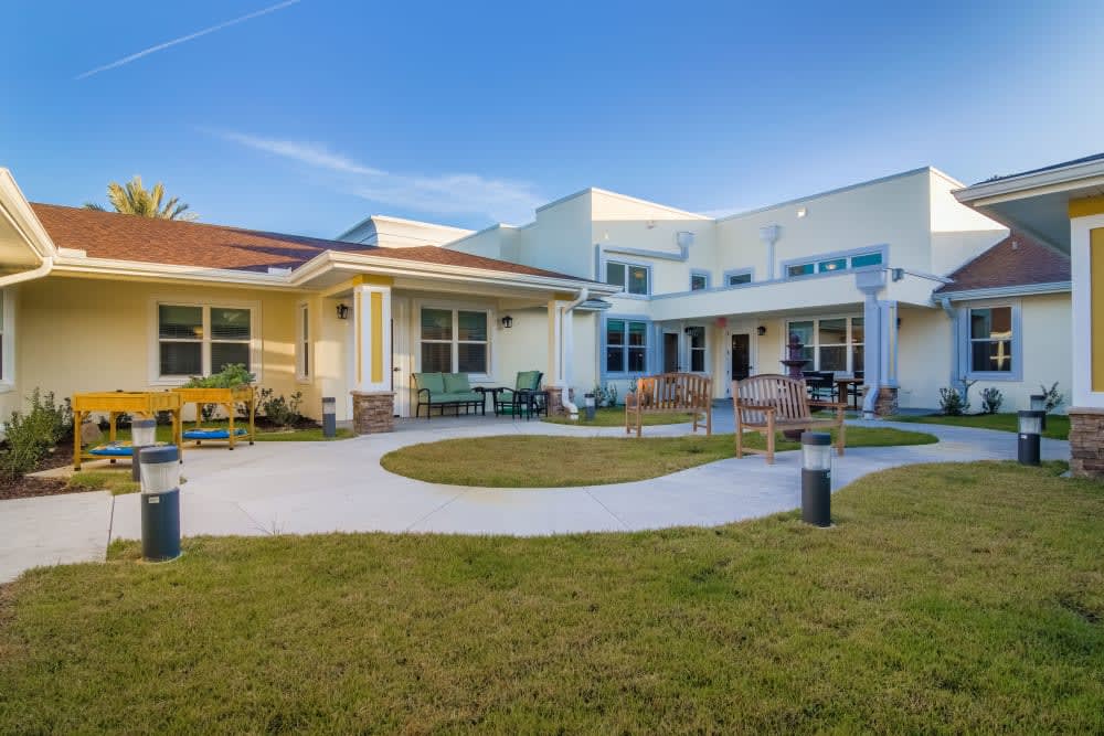 A modern house with a well-maintained lawn and outdoor seating area.