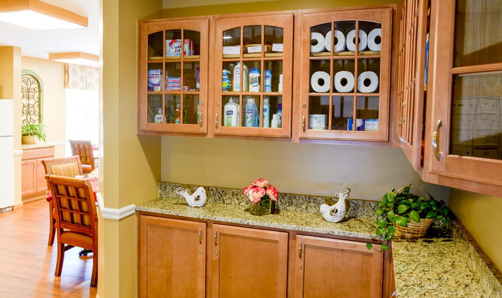 A bathroom cabinet with toiletries and toilet paper neatly organized on shelves.