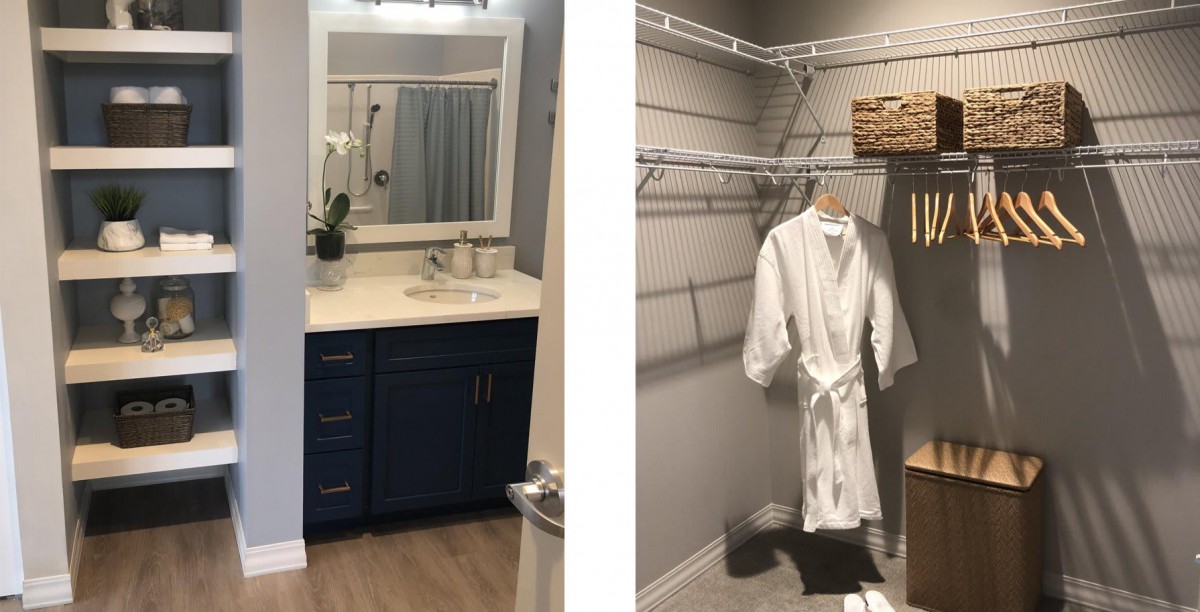A stylish bathroom with a blue vanity and an adjacent walk-in closet featuring a hanging robe.