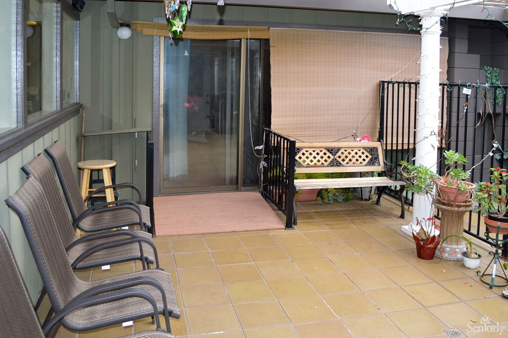 A cozy patio area with seating and plants.