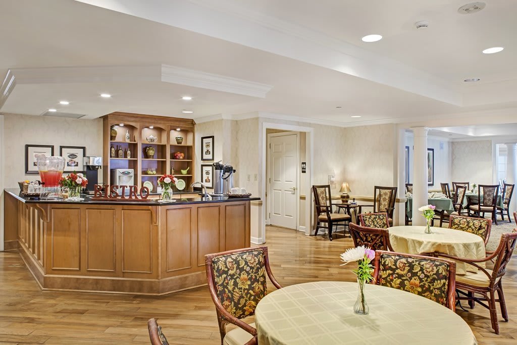 A cozy dining area with elegant furniture and a wooden bar counter.