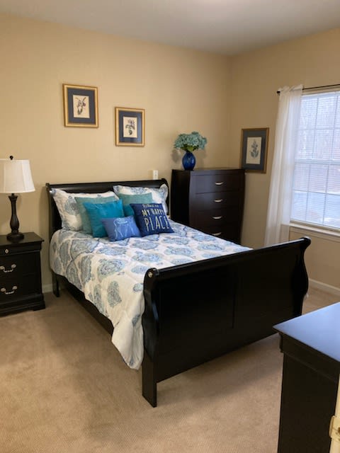 A cozy bedroom with a neatly made bed and stylish decor.