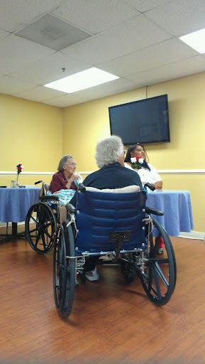 A gathering in an assisted living facility where residents are engaged in an activity.