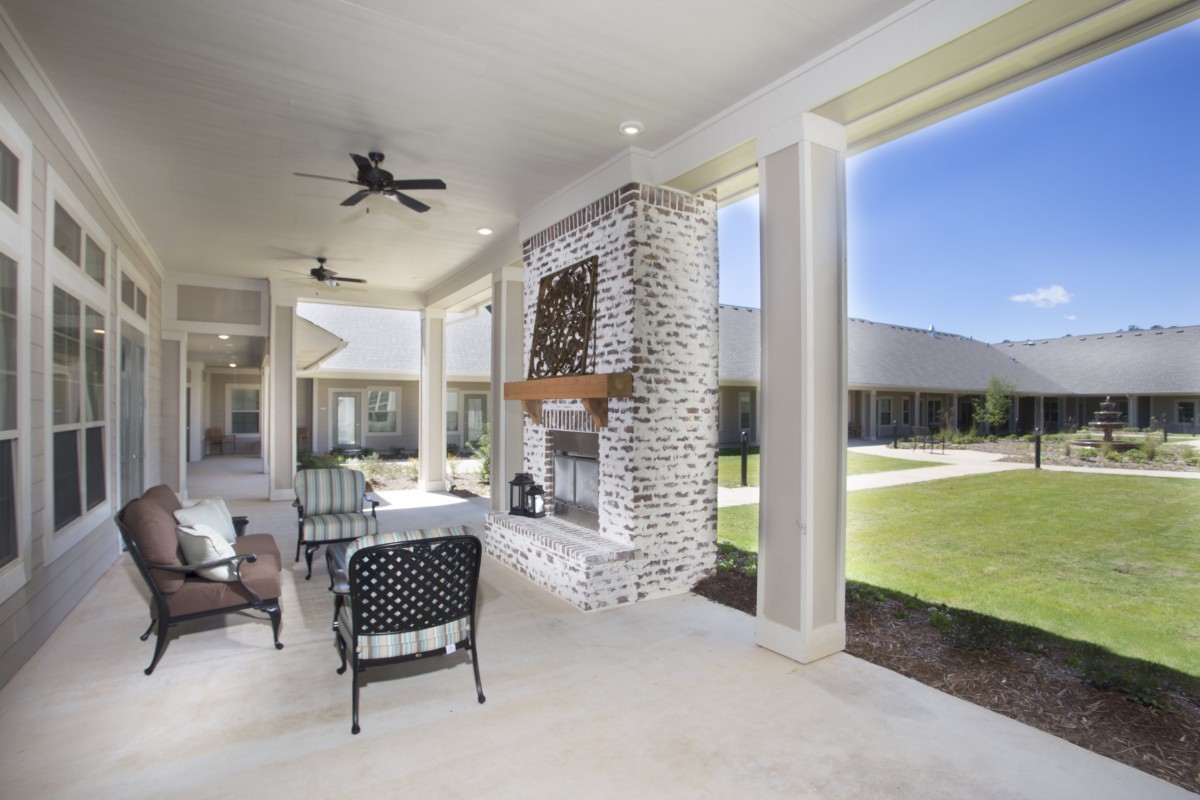 Modern outdoor patio with a cozy fireplace and comfortable seating area.