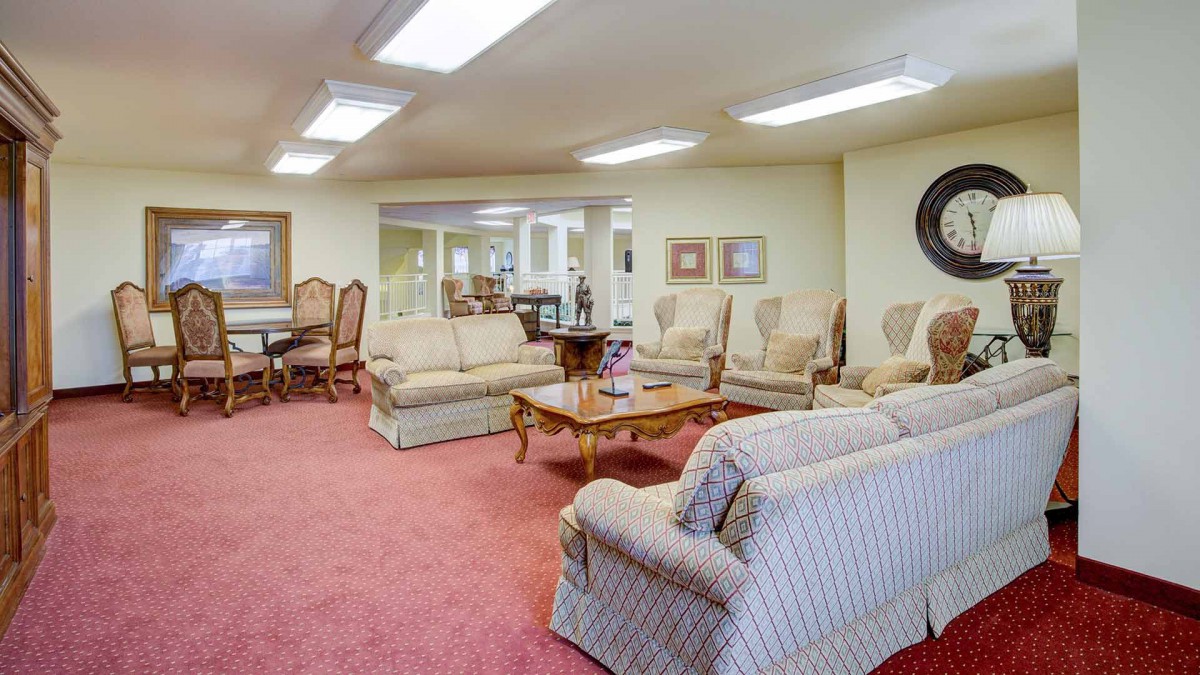 A spacious living area with comfortable seating arrangements and elegant furniture.
