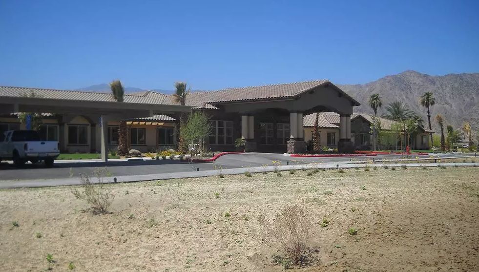 A building in a desert landscape on a sunny day.