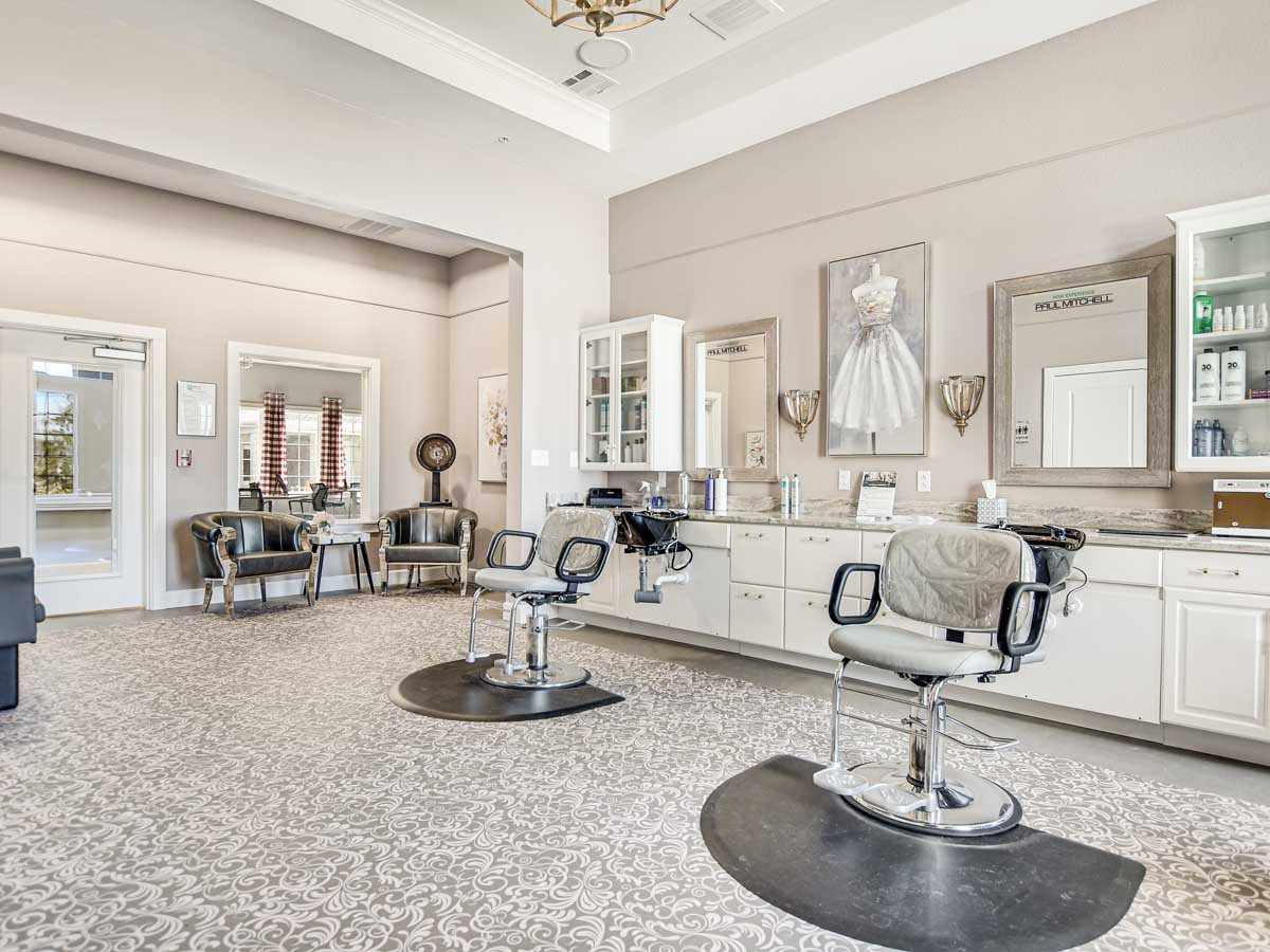 A modern salon interior with styling chairs and mirrors.