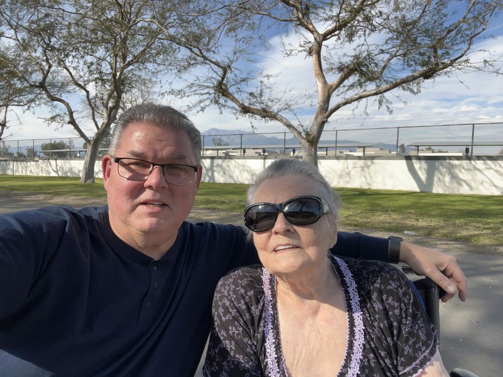 A selfie of two people enjoying a sunny day outside.