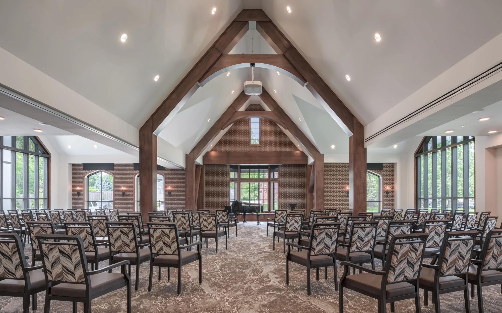 A spacious interior with a high vaulted ceiling and arranged seating.