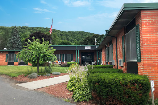 A well-maintained educational facility surrounded by lush greenery.