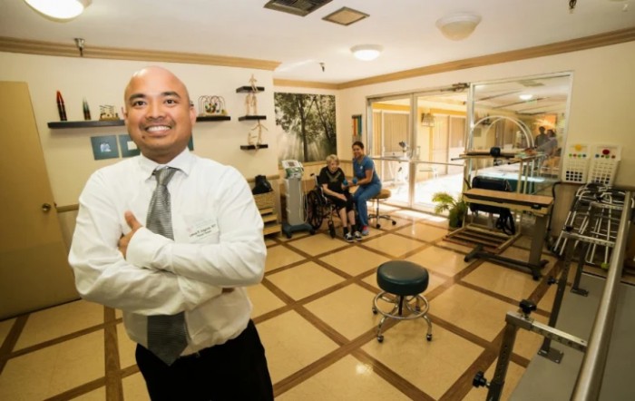 A professional smiling confidently in an office setting.